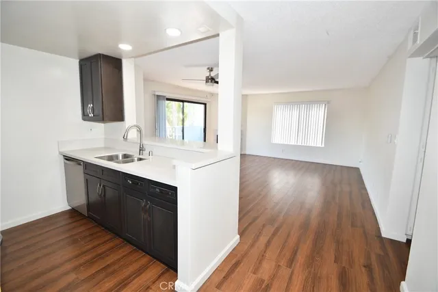 a kitchen with wooden floors and sink
