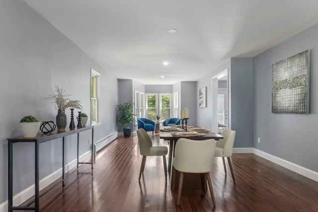 a view of a dining room with furniture window and wooden floor