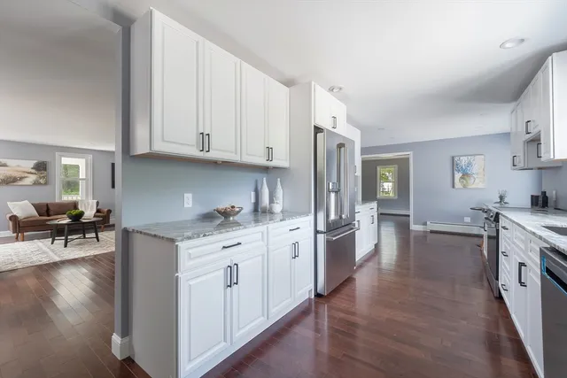 a kitchen with granite countertop a sink stove and cabinets