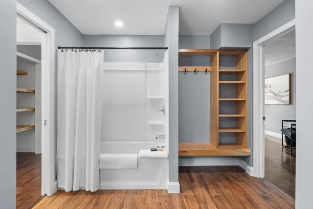 a bathroom with a bathtub and a shower