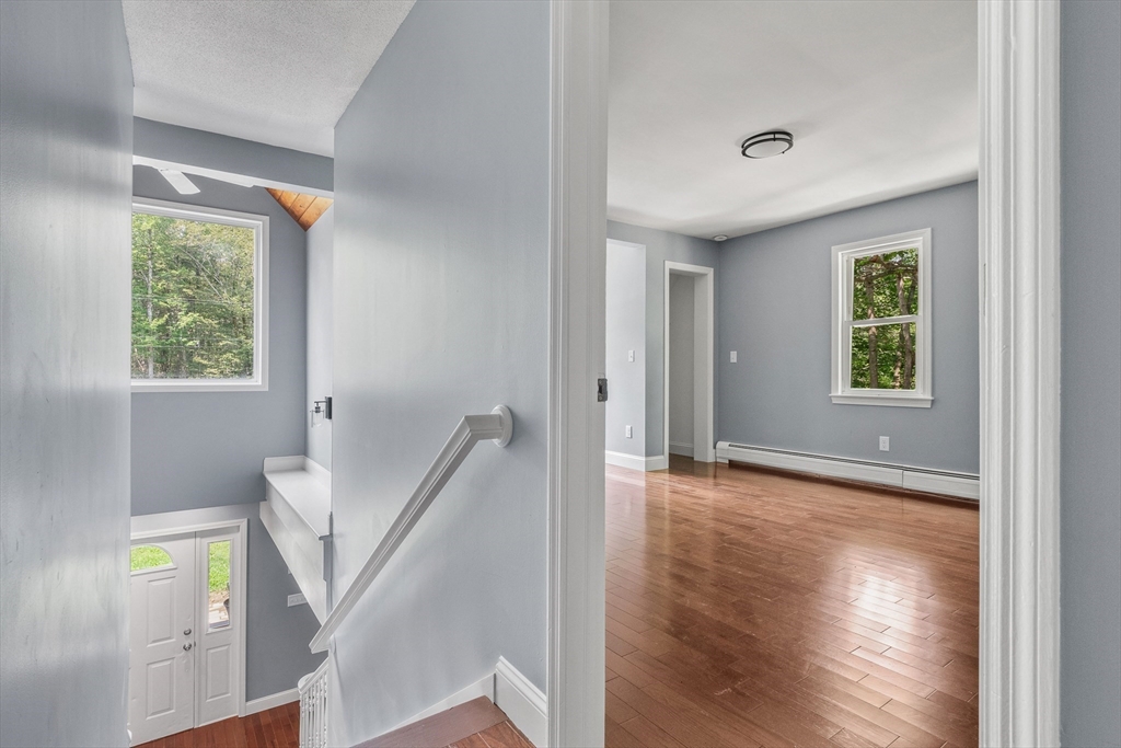 23 East Windsor Road Worthington, MA 01098 - Photo 30 of 40 a view of an empty room with wooden floor and a window