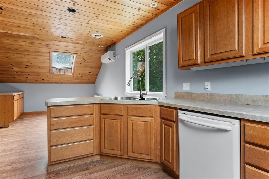 23 East Windsor Road Worthington, MA 01098 - Photo 35 of 40 a kitchen with granite countertop a sink cabinets stainless steel appliances and a window