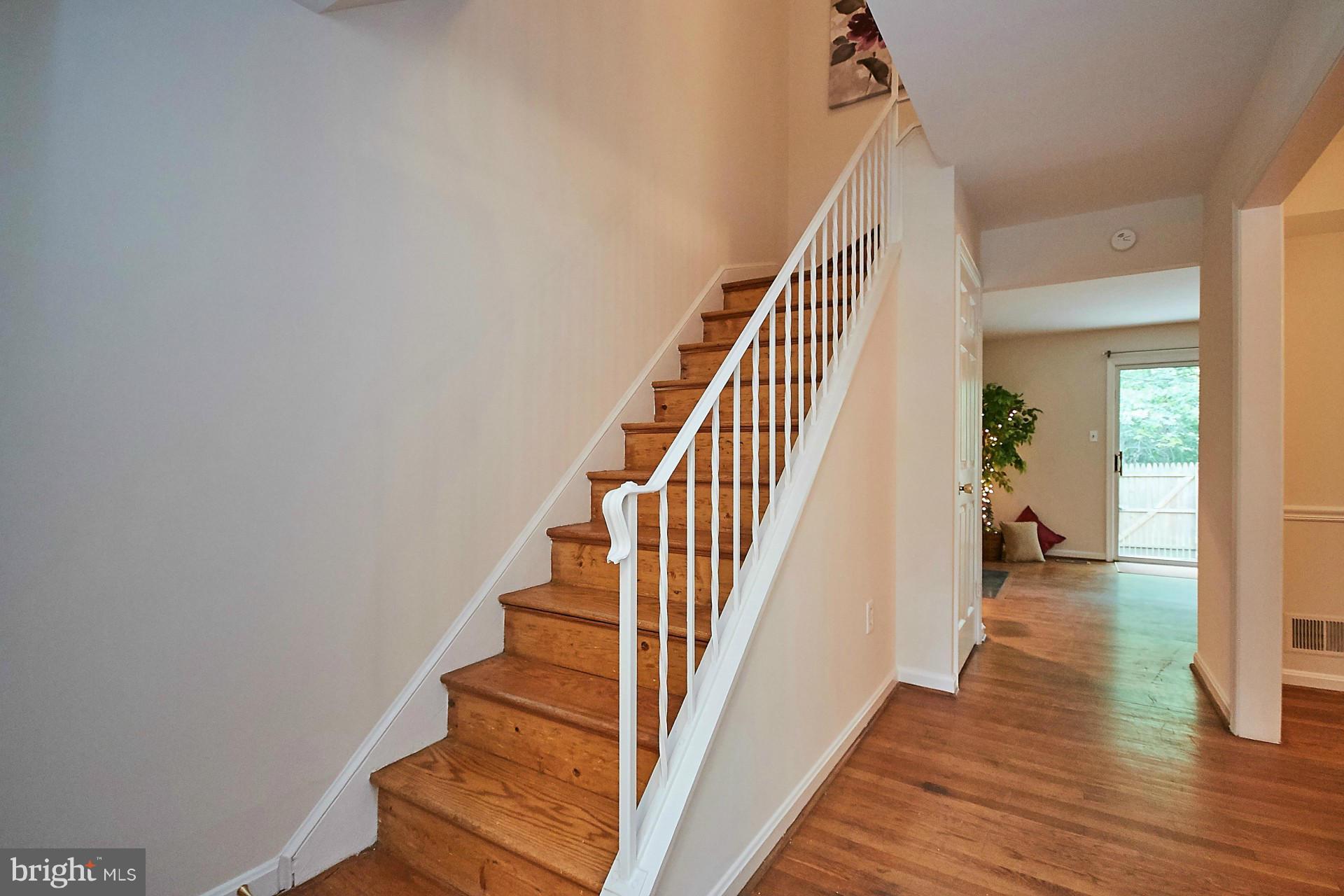 5264 Leestone Court Springfield, VA 22151 - Photo 14 of 30 a view of staircase with wooden floor and white walls