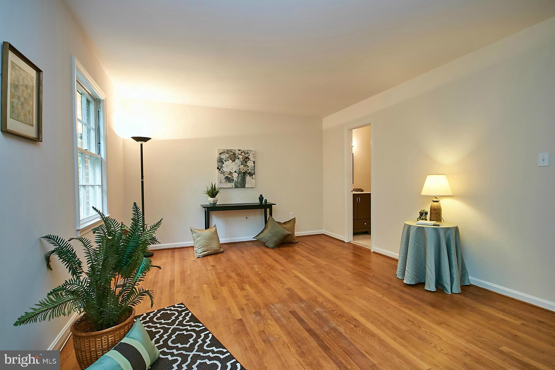 5264 Leestone Court Springfield, VA 22151 - Photo 16 of 30 a bedroom with a bed and a potted plant