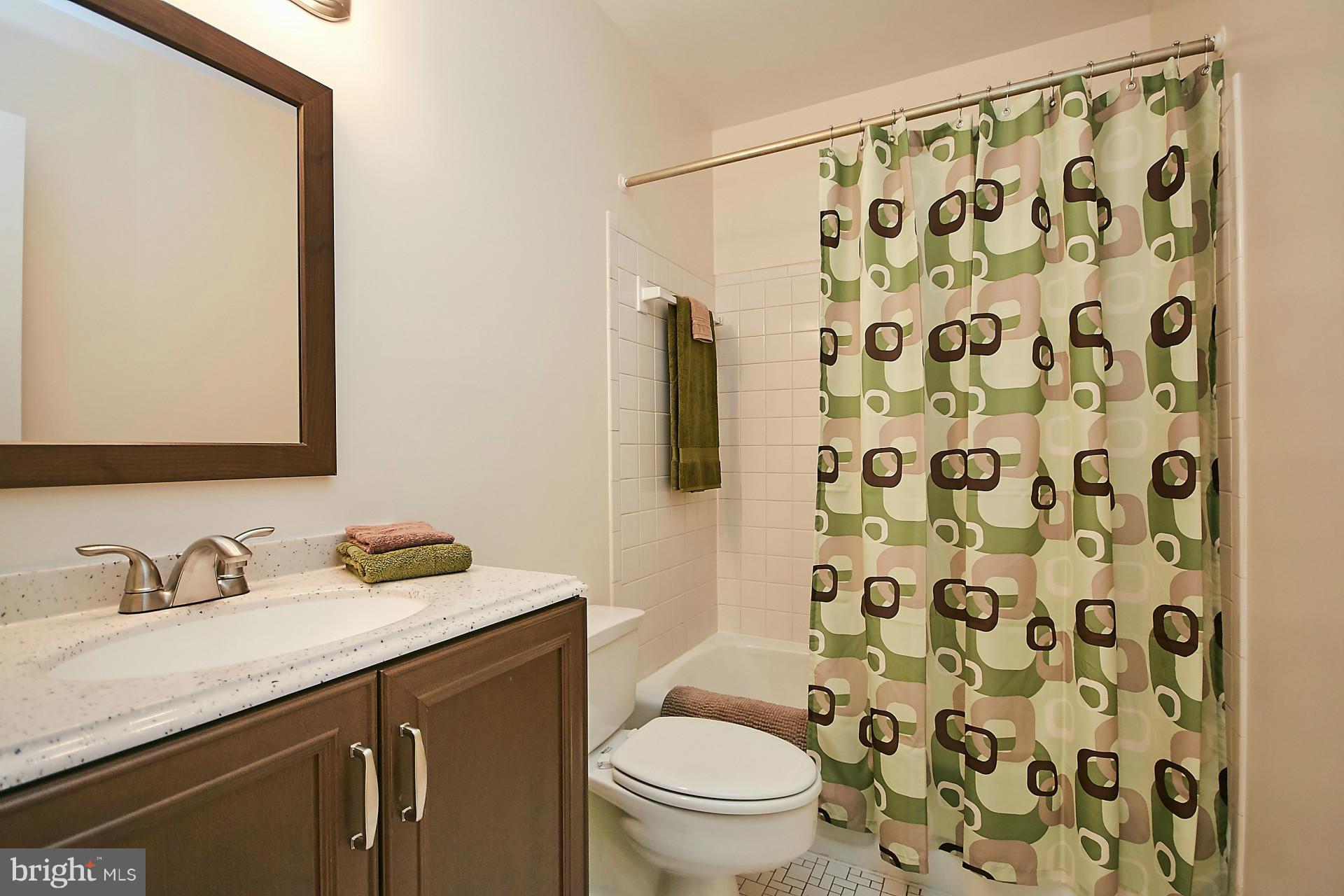 5264 Leestone Court Springfield, VA 22151 - Photo 18 of 30 a bathroom with a granite countertop sink a toilet and a mirror