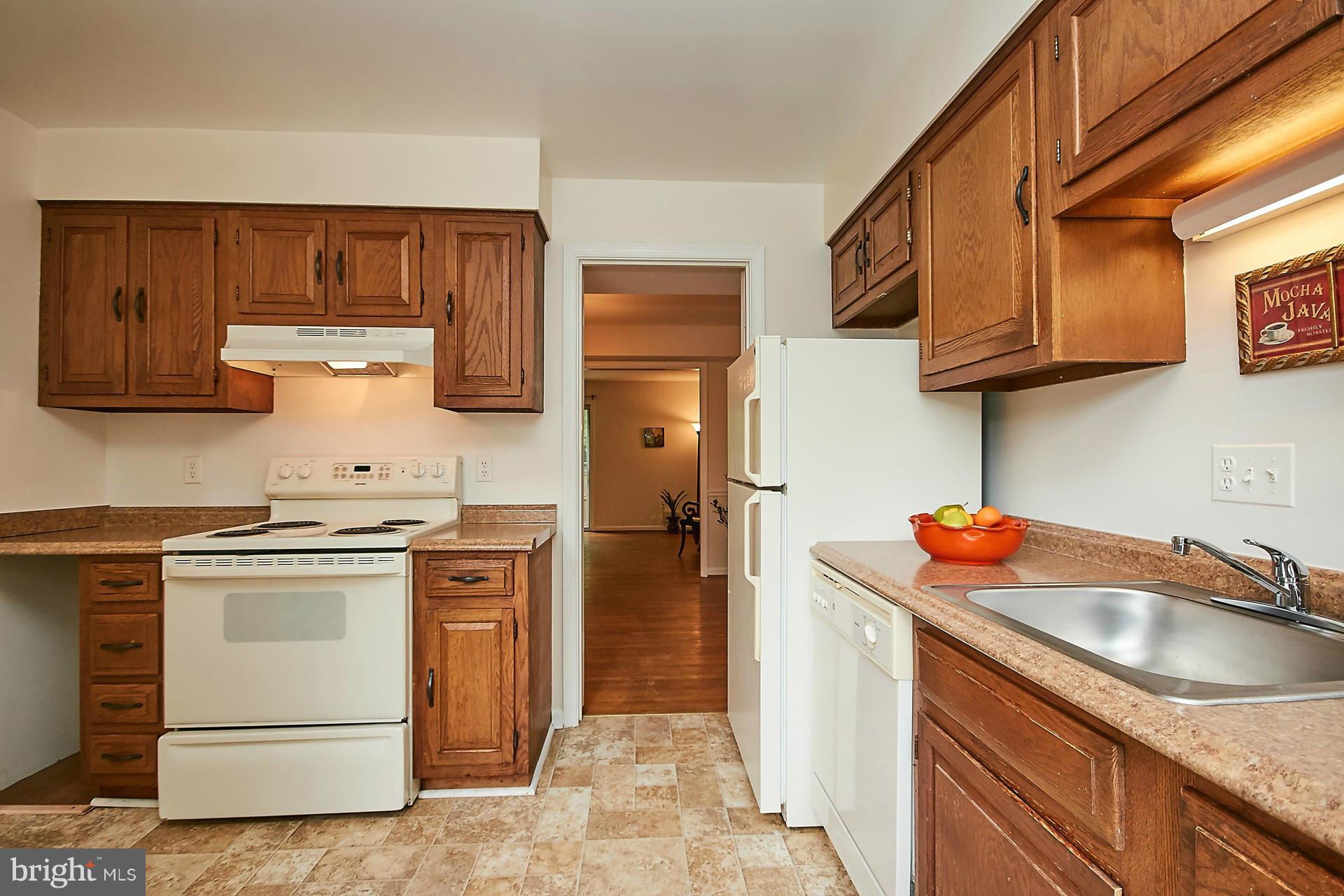 5264 Leestone Court Springfield, VA 22151 - Photo 10 of 30 a kitchen with a sink stove and cabinets