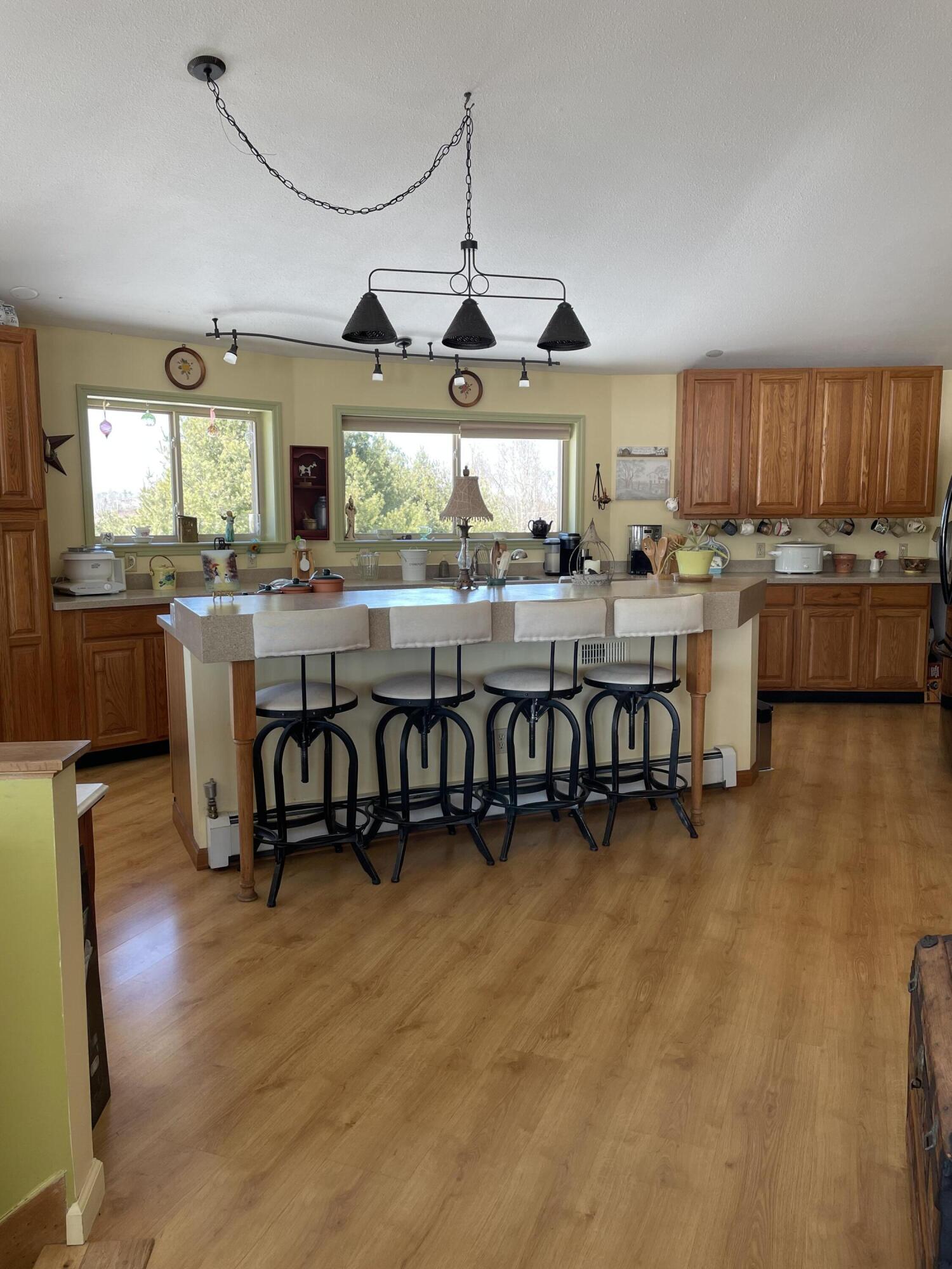 242 Sterling Bridge Road Northwest Willis, VA 24380 - Photo 11 of 32 a view of a room with kitchen island stainless steel appliances wooden floor and a window