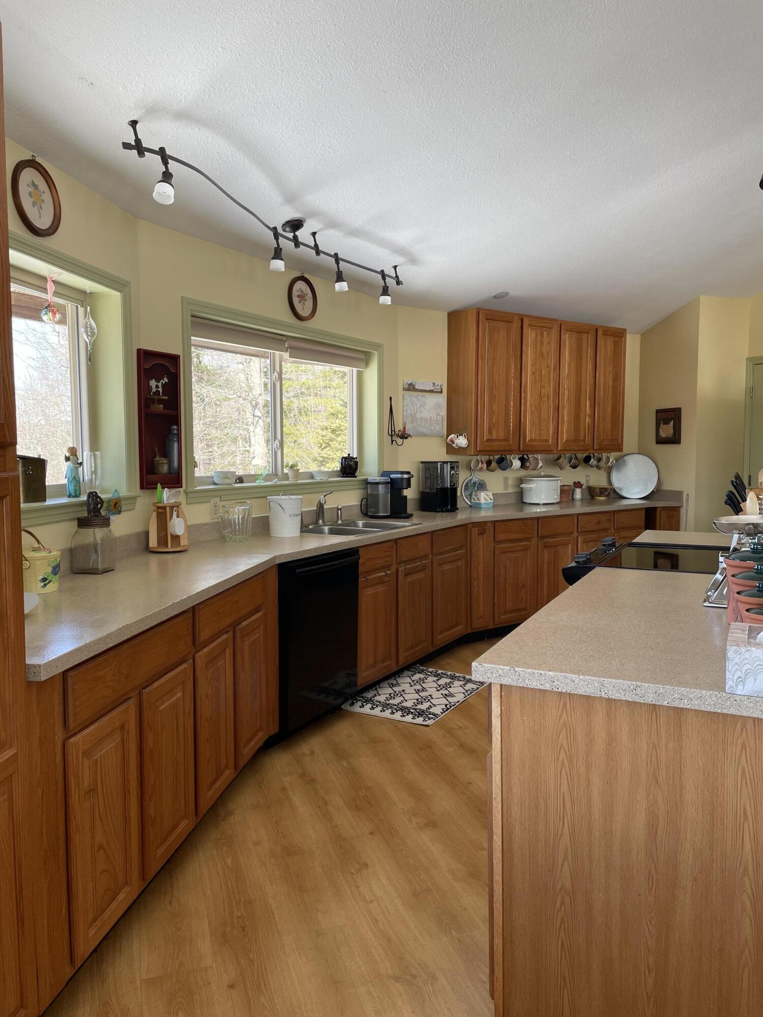 242 Sterling Bridge Road Northwest Willis, VA 24380 - Photo 12 of 32 a kitchen with granite countertop a sink stainless steel appliances and cabinets