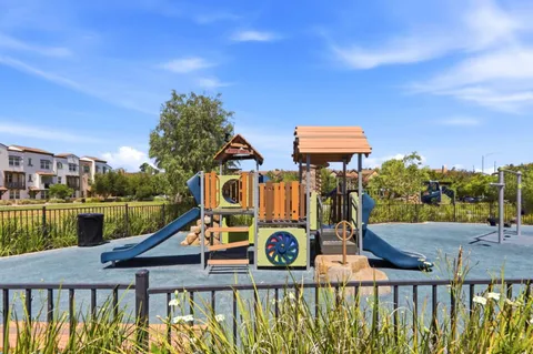 a view of a park with iron fence