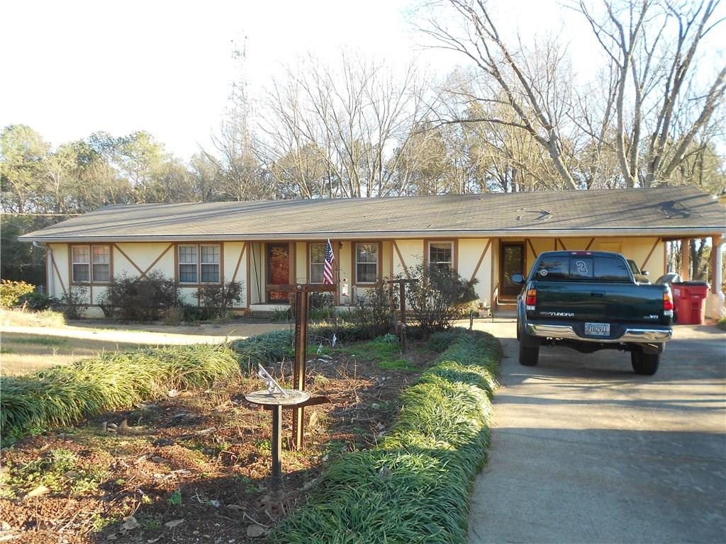4860 Bedell Road Roswell, GA 30075 - Photo 1 of 1 a view of a house with backyard and sitting area