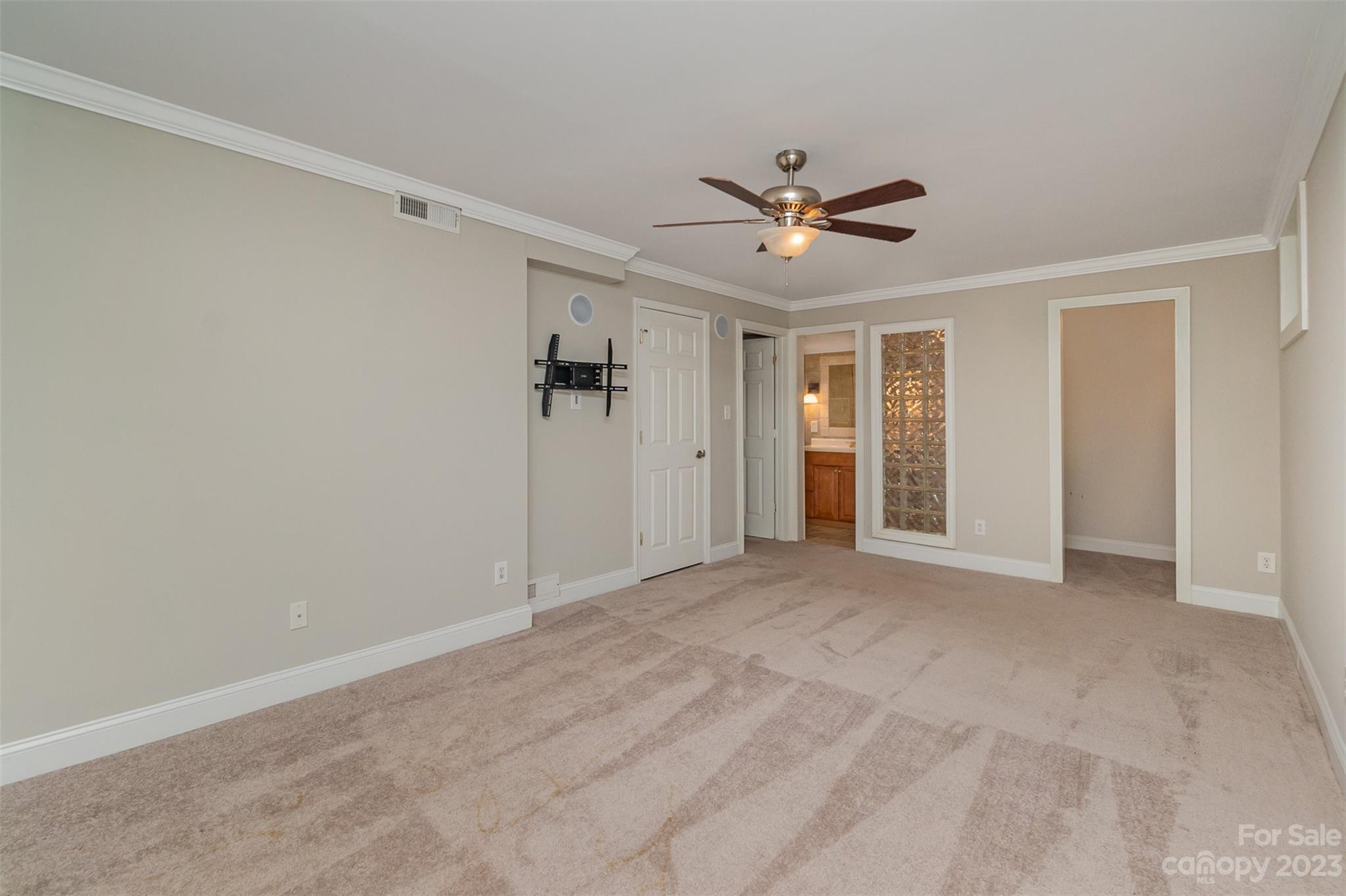 6745 Alanbrook Road Charlotte, NC 28215 - Photo 11 of 28 a view of a livingroom with a ceiling fan & entryway