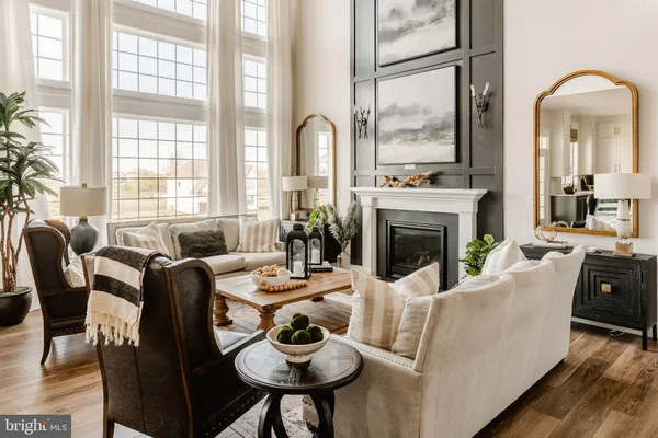 a living room with furniture fireplace and a large window