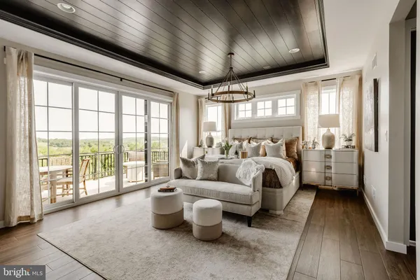 a bedroom with furniture and a large window