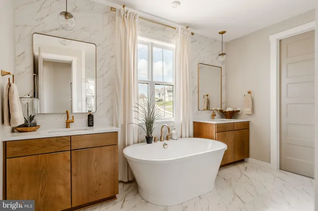 a bathroom with a tub sink and mirror