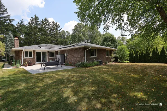 a front view of house with yard patio and green space