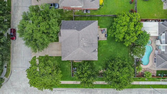 an aerial view of a house with garden space and a street view
