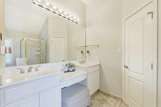 a bathroom with a sink double vanity and a mirror