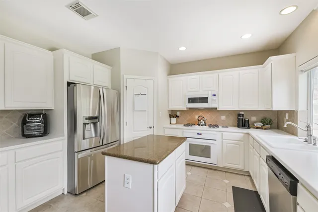 a kitchen with a sink stove and refrigerator