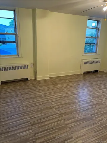 a view of a room with wooden floor