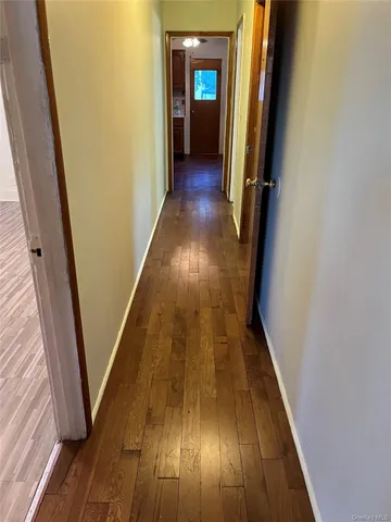 a view of a room with wooden floors and window