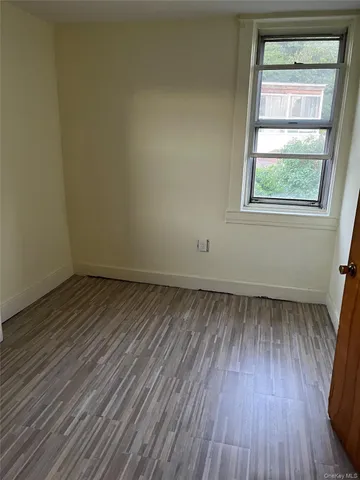 a view of a room with wooden floor and windows