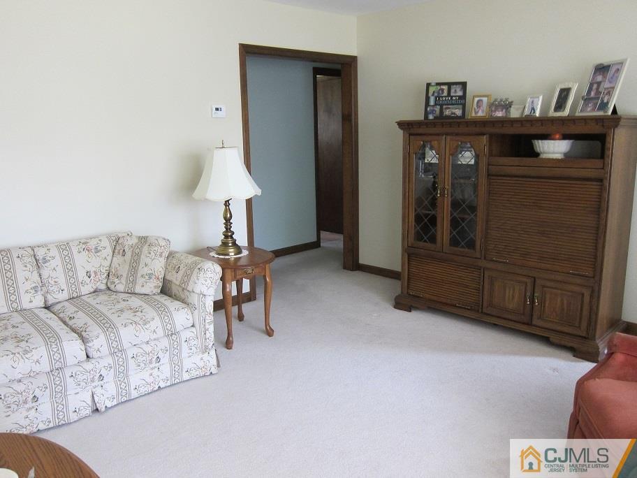 41 Colton Road Edison, NJ 08817 - Photo 8 of 16 a living room with furniture and a lamp