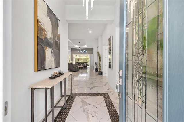 a living room with stainless steel appliances kitchen island granite countertop furniture and a large window