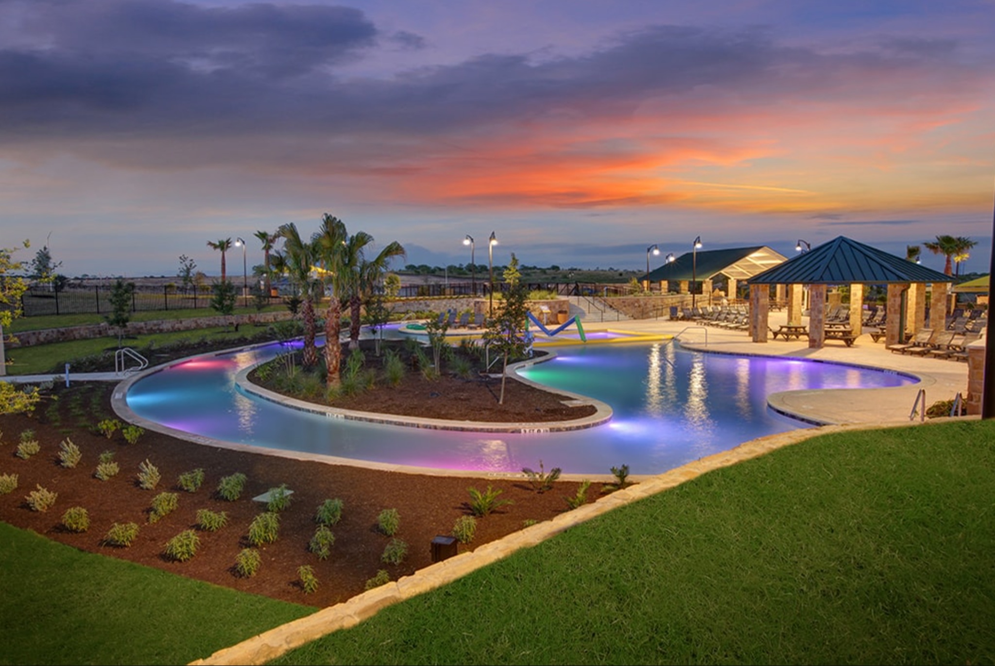 189 Durian Loop Buda, TX 78610 - Photo 36 of 38 Pool at dusk featuring a community pool and a patio