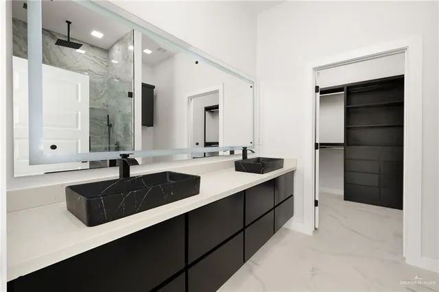a bathroom with a sink double vanity and a mirror