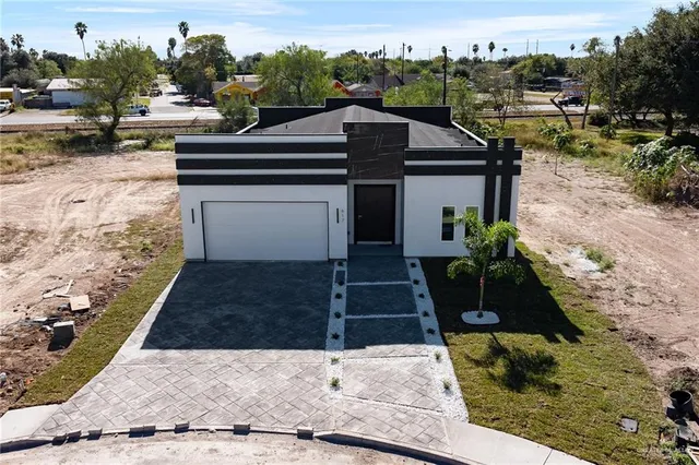 an aerial view of a house with a yard