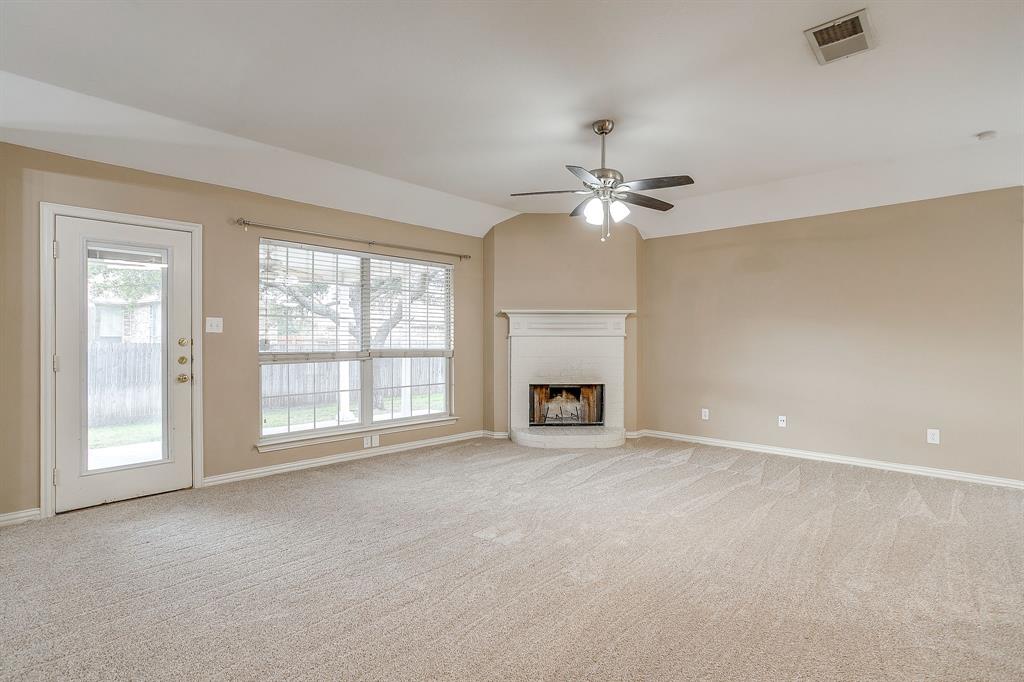 177 Aspen Loop Aledo, TX 76008 - Photo 16 of 40 a view of an empty room with a fireplace and a window
