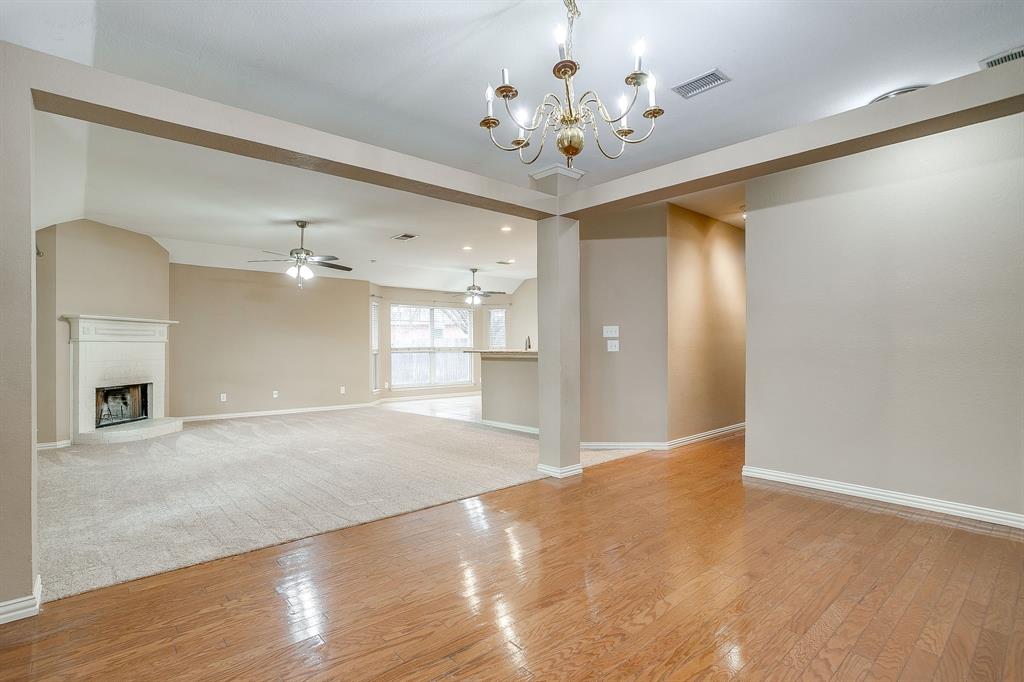 177 Aspen Loop Aledo, TX 76008 - Photo 23 of 40 a view of a livingroom with a chandelier fan and kitchen view