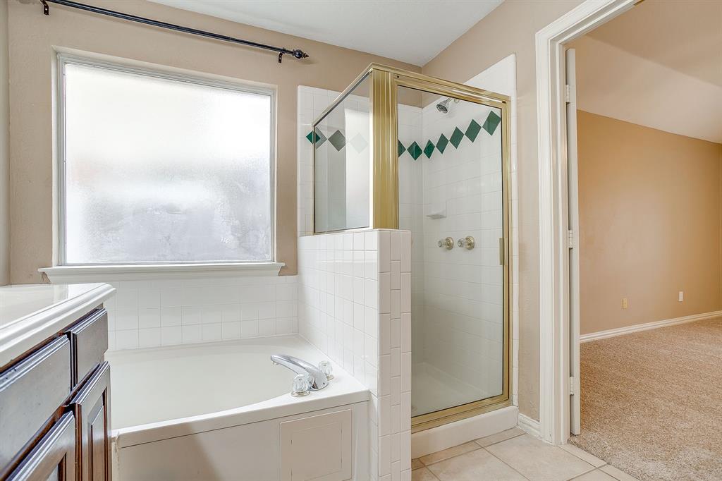 177 Aspen Loop Aledo, TX 76008 - Photo 28 of 40 a bathroom with a bathtub and a shower