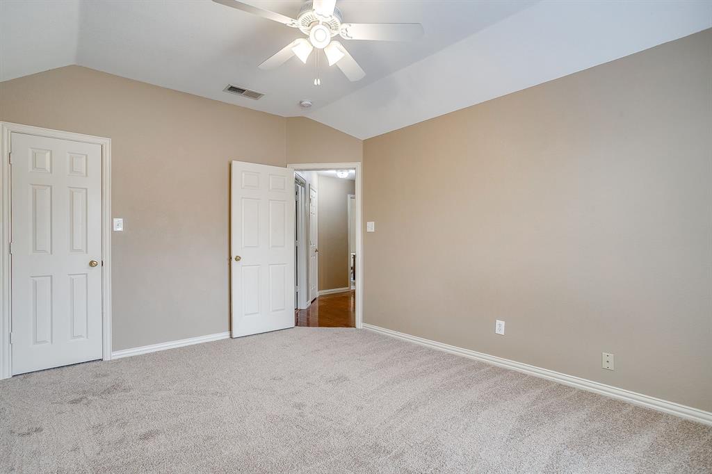 177 Aspen Loop Aledo, TX 76008 - Photo 33 of 40 an empty room with a chandelier fan and a chandelier fan