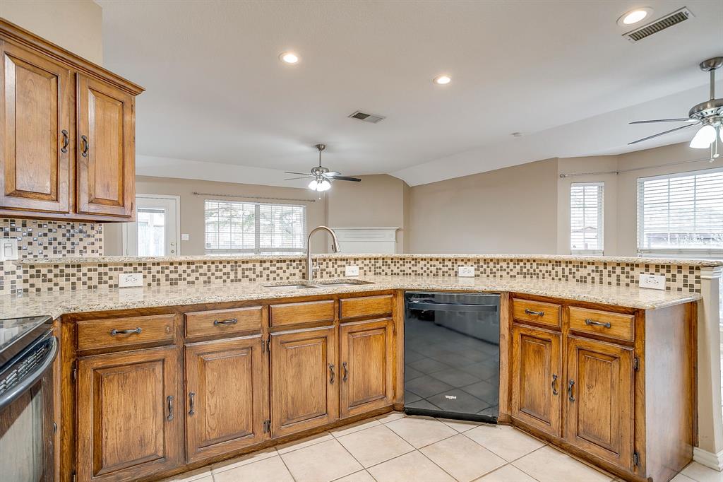 177 Aspen Loop Aledo, TX 76008 - Photo 5 of 40 a kitchen with a sink stove and cabinets