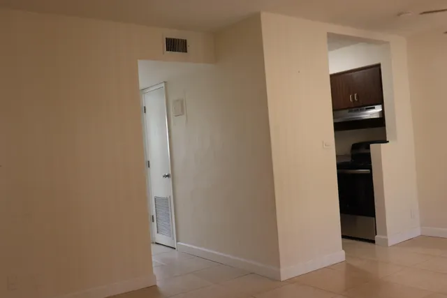 an empty room with sliding door and windows