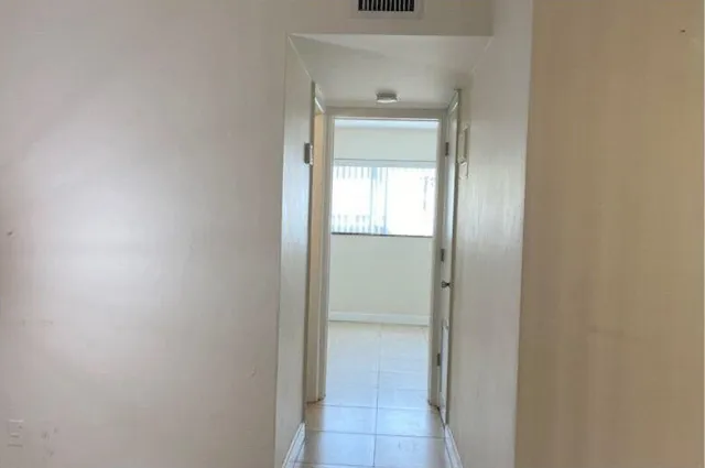 an empty room that has a wooden door