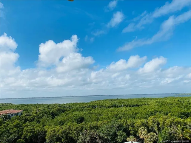 a bedroom with bed and a large window