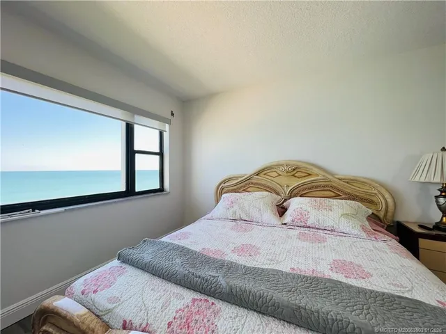 a en suite bathroom with a granite countertop sink and a mirror