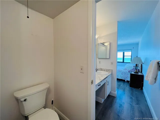 a view of walk in closet and bedroom