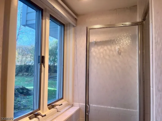 a bathroom with a glass shower door