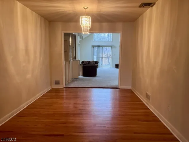 a view of a living room with wooden floor