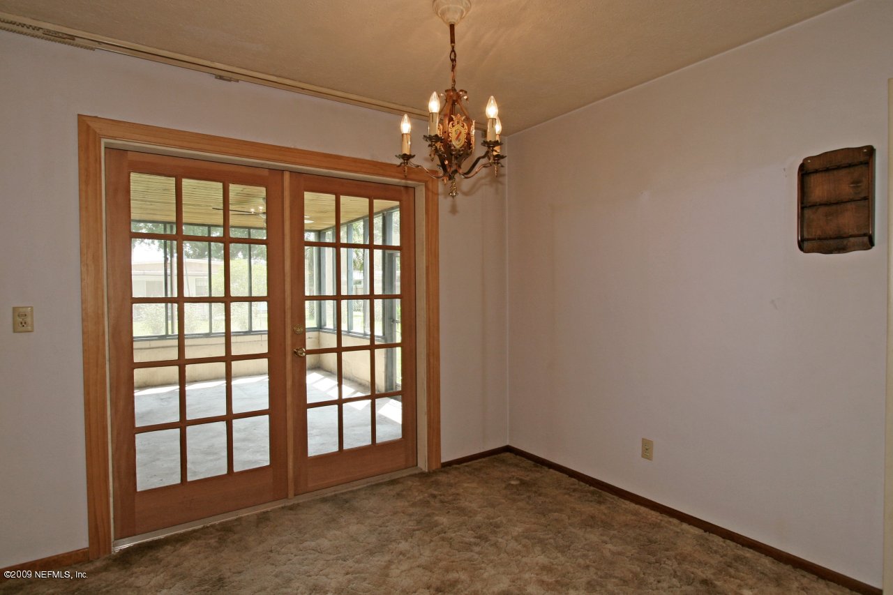 4603 Ruckner Road Jacksonville, FL 32207 - Photo 6 of 11 a view of a livingroom with a chandelier fan and windows