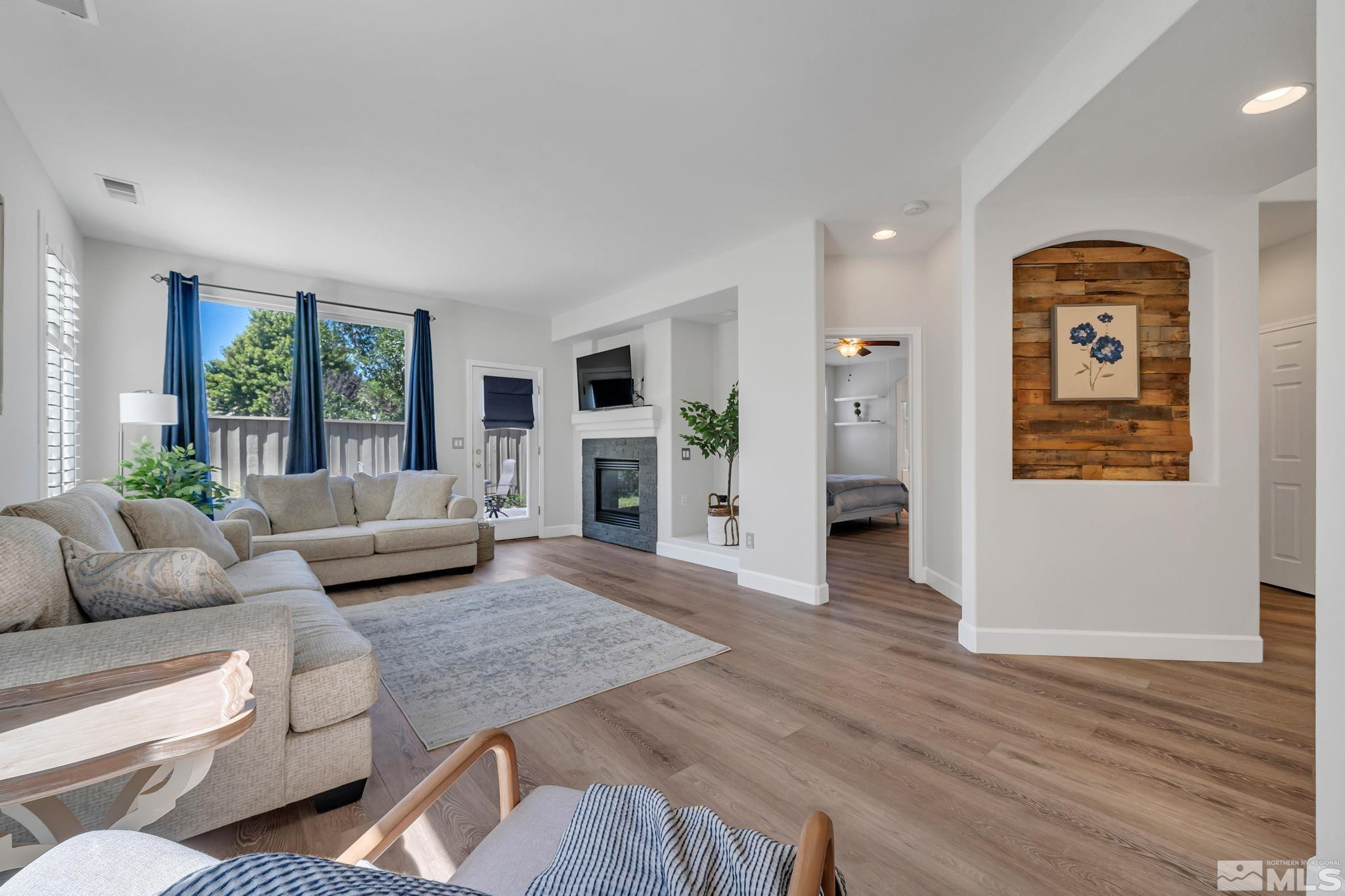 a living room with furniture and a fireplace