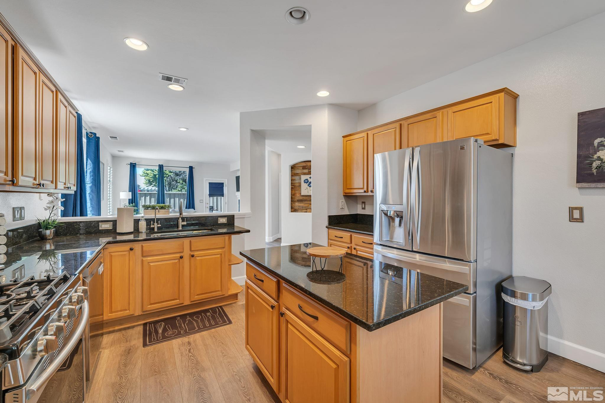 10459 Summershade Lane Reno, NV 89521 - Photo 12 of 37 a kitchen with granite countertop a sink refrigerator and microwave