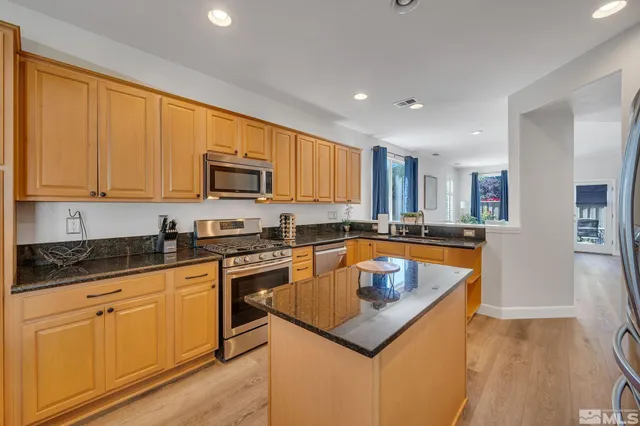 a kitchen with granite countertop a sink and cabinets