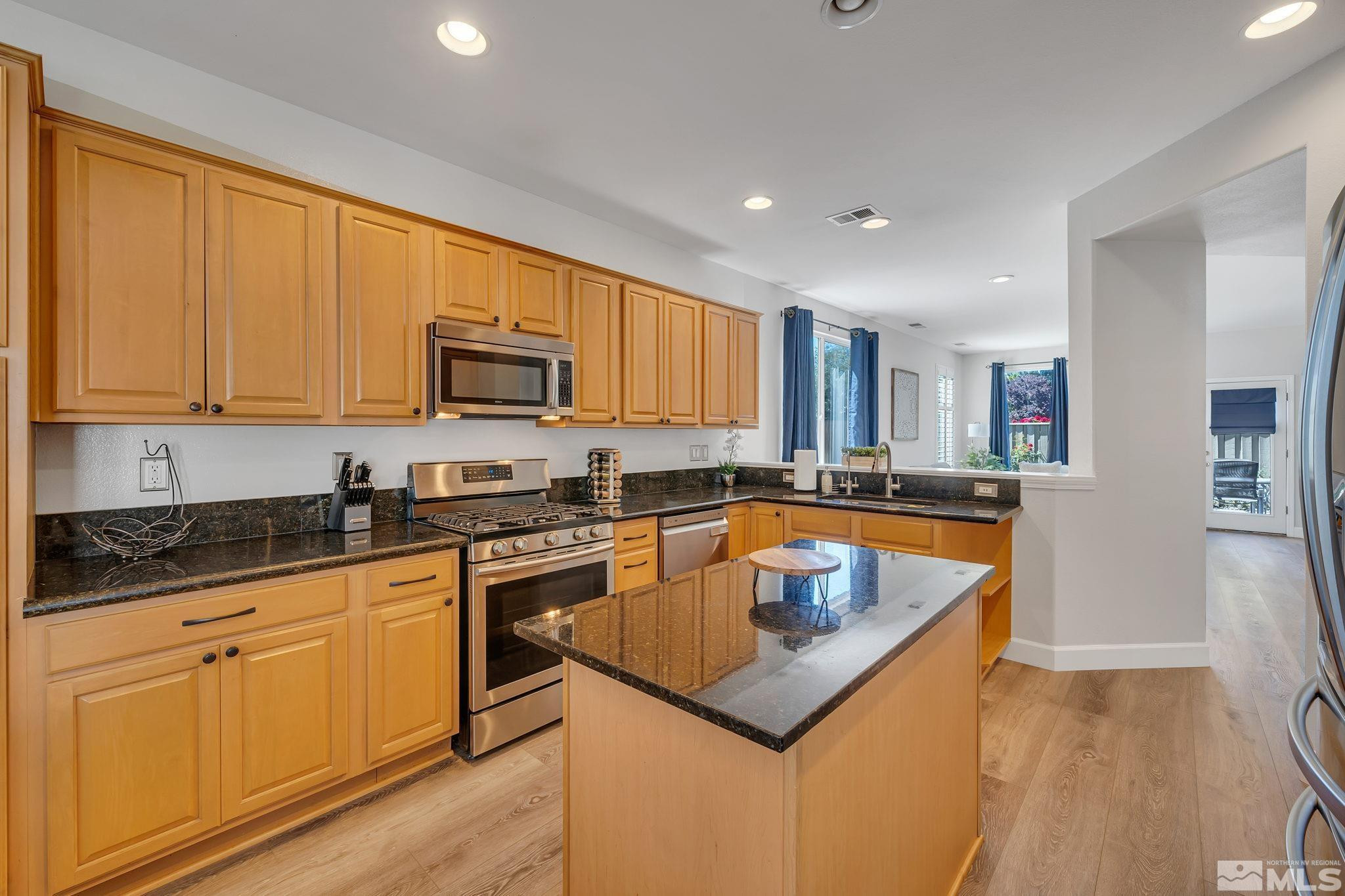 10459 Summershade Lane Reno, NV 89521 - Photo 14 of 37 a kitchen with granite countertop a sink and cabinets