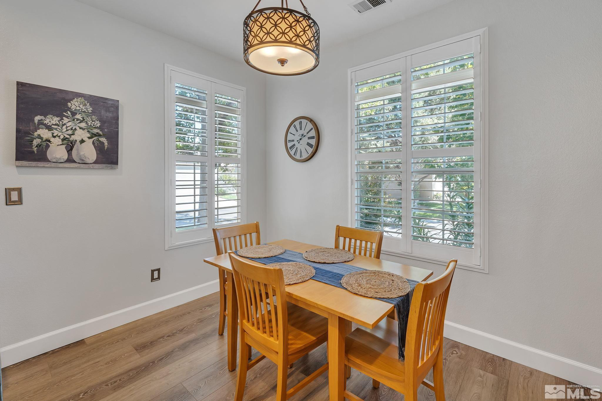 10459 Summershade Lane Reno, NV 89521 - Photo 16 of 37 a view of a dining room with furniture window and wooden floor