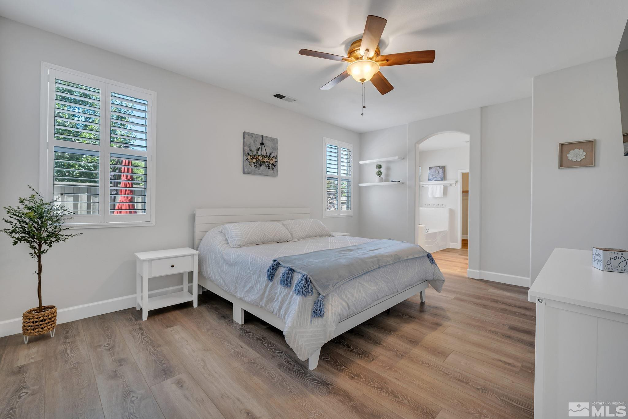 10459 Summershade Lane Reno, NV 89521 - Photo 18 of 37 a bedroom with a bed and a chandelier