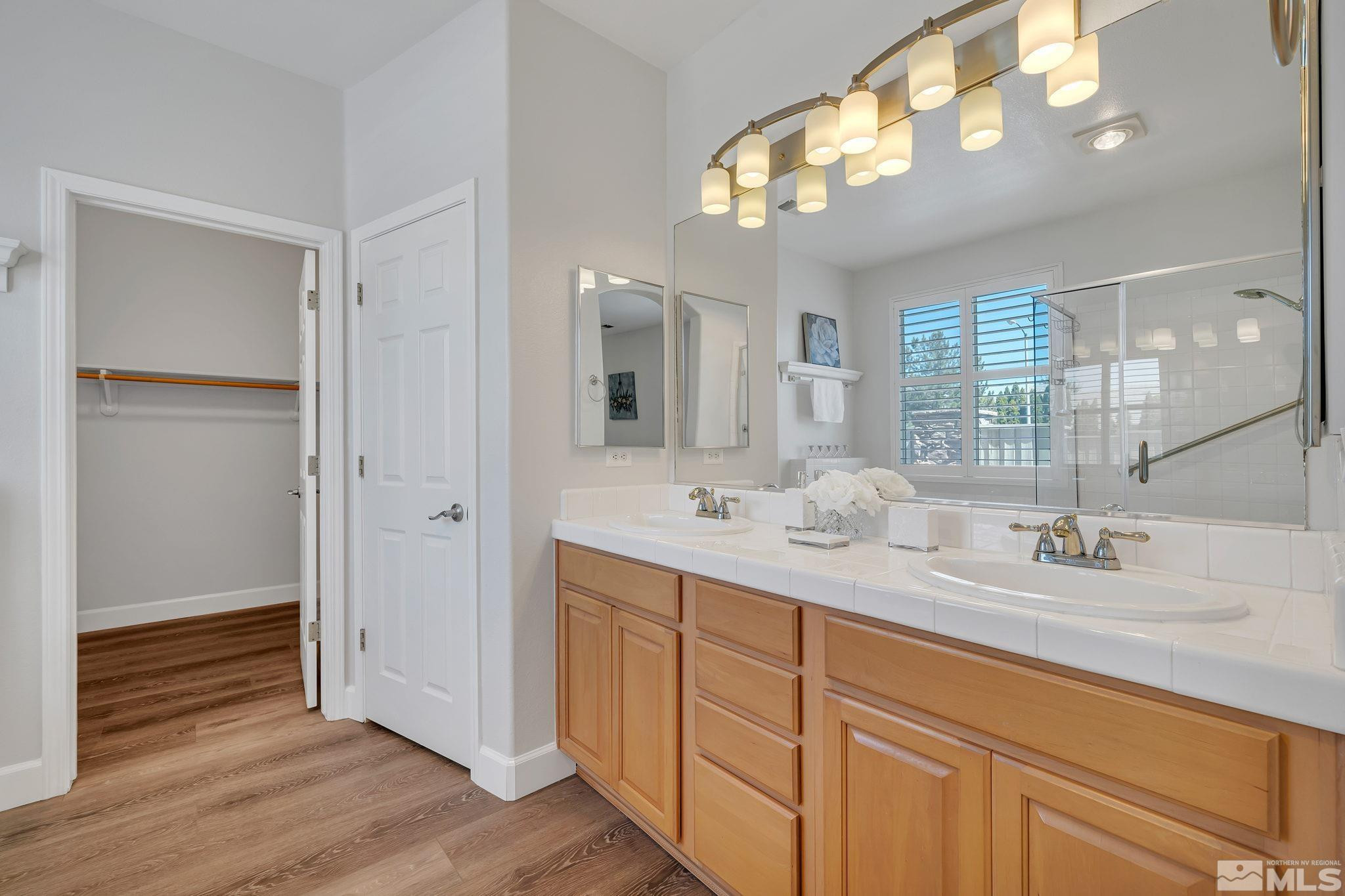 10459 Summershade Lane Reno, NV 89521 - Photo 20 of 37 a bathroom with double vanity and a mirror
